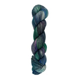 A skein of hand-dyed fingering/sock yarn color blue teal green purple grey