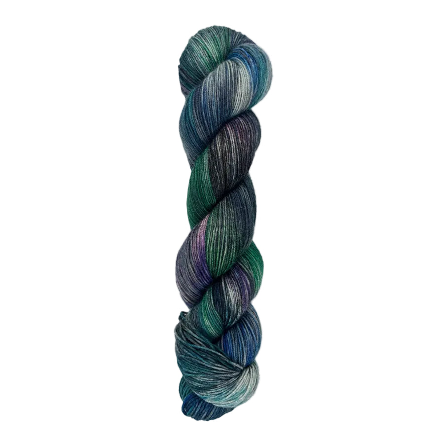 A skein of hand-dyed fingering/sock yarn color blue teal green purple grey