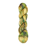 A skein of hand-dyed fingering/sock yarn color tan and green speckles