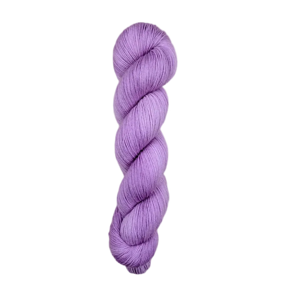 Purple skein of yarn on a light wooden surface