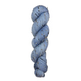 Blue skein of yarn with speckles on a white background