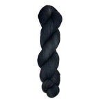Skein of hand dyed fingering weight yarn in the color black