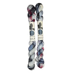 Two mini skeins of wool yarn hand dyed in Wyoming in the color white blue black red