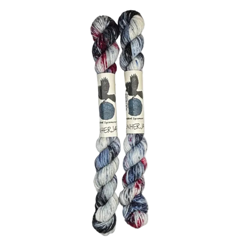 Two mini skeins of wool yarn hand dyed in Wyoming in the color white blue black red