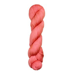 A skein of hand-dyed fingering/sock yarn color salmon pink
