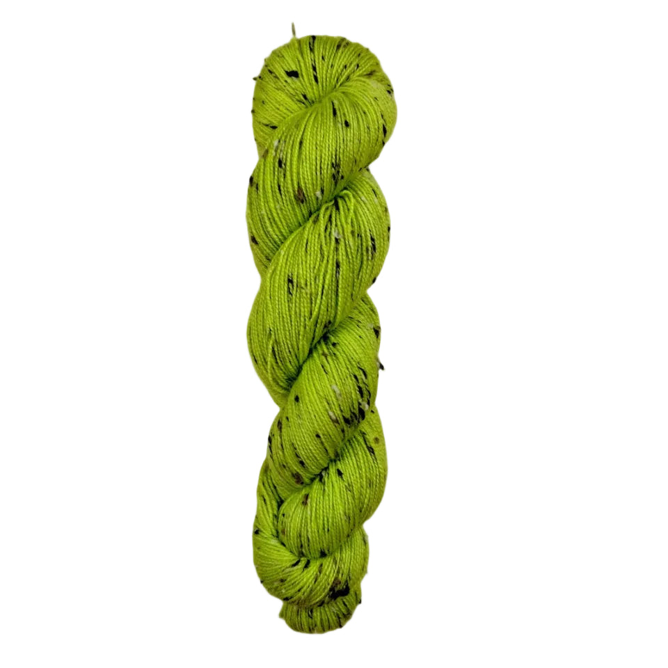 Green skein of yarn on a wooden surface