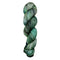 A skein of hand-dyed fingering/sock yarn color grey green black speckles
