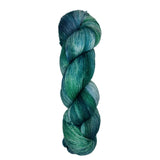 Skein of hand dyed fingering weight yarn in the color blue teal green 