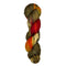 Skein of hand dyed fingering weight yarn in the color brown offwhite red orange black speckles