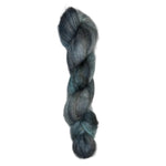 Skein of mohair silk yarn hand-dyed in Wyoming in the color grey blue black