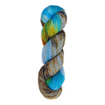 A skein of hand-dyed fingering/sock yarn color blue yellow grey orange brown green speckles