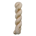 A skein of hand-dyed fingering/sock yarn color off white pink tan