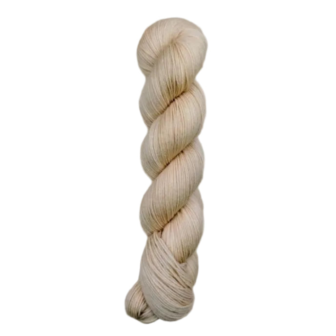 A skein of hand-dyed fingering/sock yarn color off white pink tan