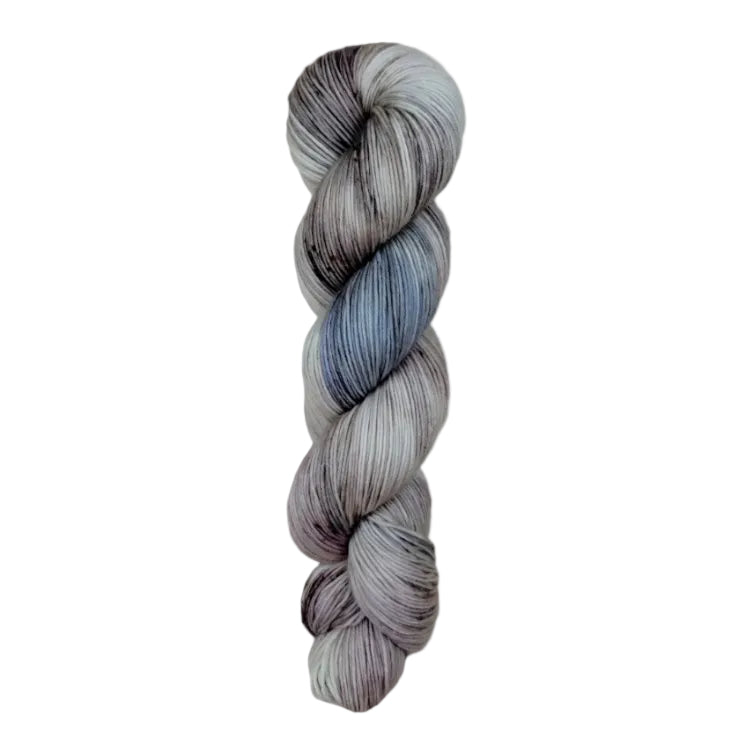 A skein of hand-dyed fingering/sock yarn color grey blue black speckles