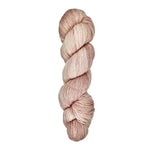 A skein of hand-dyed fingering/sock yarn color dusty pink