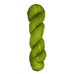 Skein of hand dyed fingering weight yarn in the color pea green 