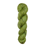 Green skein of yarn with black speckles on a white background