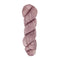 A skein of hand-dyed fingering/sock yarn color dusty pink