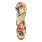 A skein of hand-dyed fingering/sock yarn color tan red and blue speckles