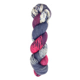 A skein of hand-dyed fingering/sock yarn color red black grey white speckles