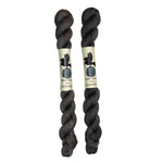 Mini skeins of hand dyed fingering weight yarn in the color dark grey