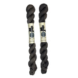 Mini skeins of hand dyed fingering weight yarn in the color dark grey