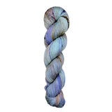 A skein of hand-dyed fingering/sock yarn color grey periwinkle brown peach brown speckles