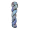 A skein of hand-dyed fingering/sock yarn color grey periwinkle brown peach brown speckles