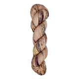 A skein of hand-dyed fingering/sock yarn color pink brown burgundy speckles