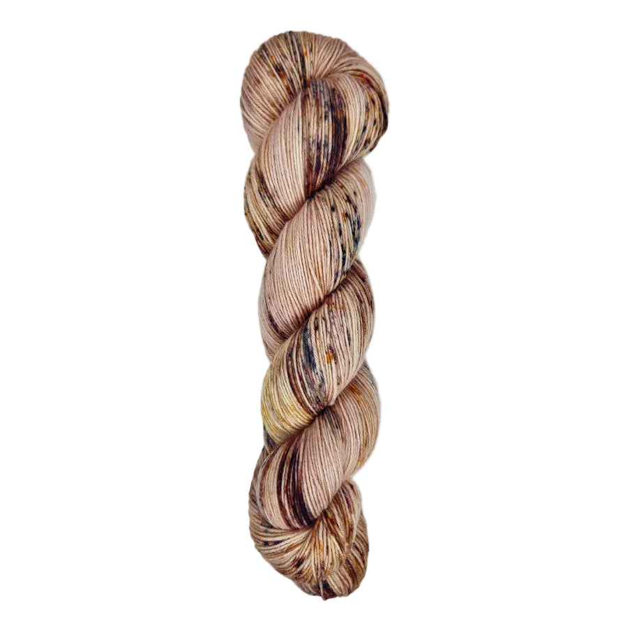 A skein of hand-dyed fingering/sock yarn color pink brown burgundy speckles