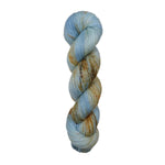 A skein of hand-dyed fingering/sock yarn color blue tan orange brown speckles