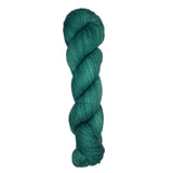 Skein of hand dyed fingering weight yarn in the color spruce green
