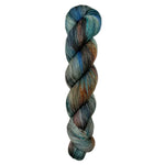 A skein of hand-dyed fingering/sock yarn color grey blue orange brown red black speckles