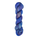 A skein of hand-dyed fingering/sock yarn color blue grey purple