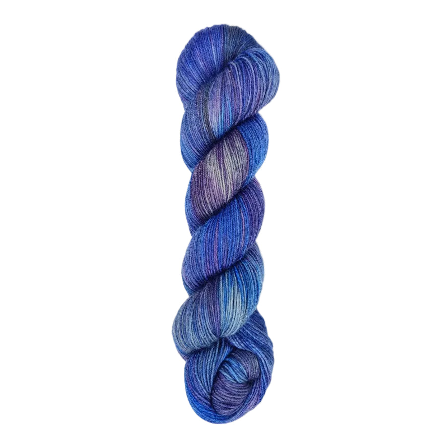 A skein of hand-dyed fingering/sock yarn color blue grey purple