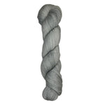 Skein of hand dyed fingering weight yarn in the color grey