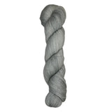 Skein of hand dyed fingering weight yarn in the color grey