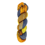 A skein of hand-dyed fingering/sock yarn color orange grey navy yellow black speckles