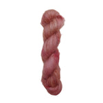 A single twisted skein of soft, fuzzy yarn in a dusty rose pink color