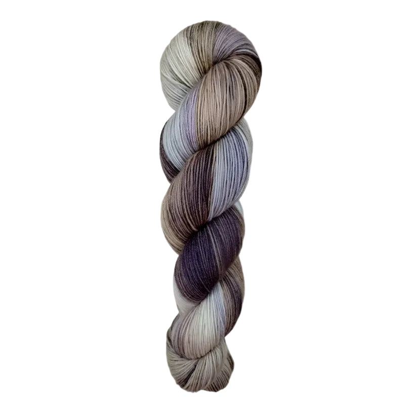 A skein of hand-dyed fingering/sock yarn color white grey tan blue brown