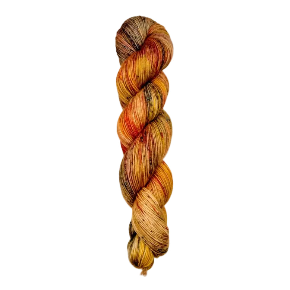 A skein of hand-dyed fingering/sock yarn color orange brown red speckles