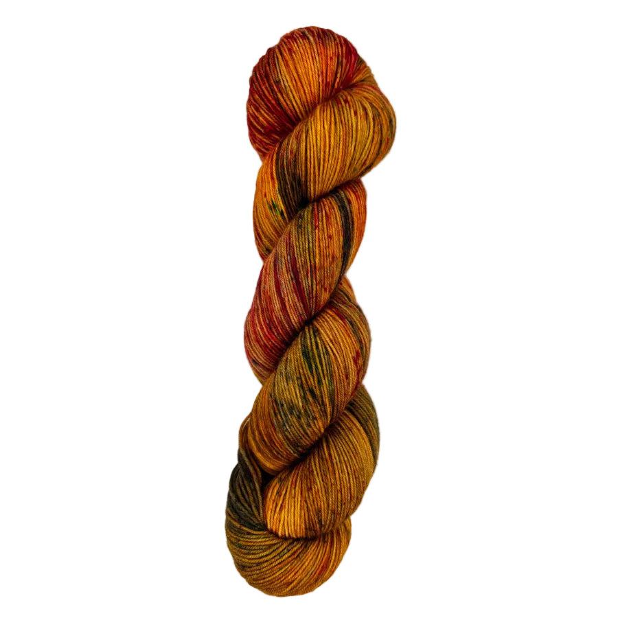A skein of hand-dyed fingering/sock yarn color burnt orange red brown green speckles