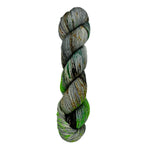 A skein of hand-dyed fingering/sock yarn color grey green  orange brown speckles