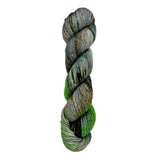 A skein of hand-dyed fingering/sock yarn color grey green  orange brown speckles