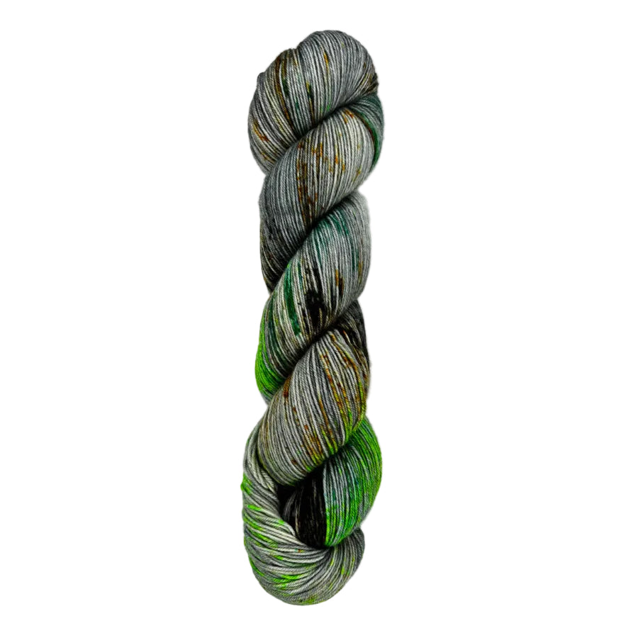 A skein of hand-dyed fingering/sock yarn color grey green  orange brown speckles