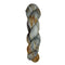 Skein of hand dyed fingering weight yarn in the color grey orange black speckles
