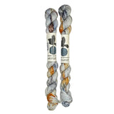 Two mini skeins of wool yarn hand dyed in Wyoming in the color grey blue orange speckles