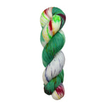 A skein of hand-dyed fingering/sock yarn color white yellow blue green red speckles