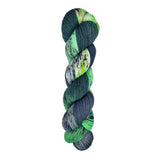 A skein of hand-dyed fingering/sock yarn color green white grey black speckles