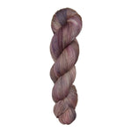 Fingering weight yarn skein with purple, pink, and brown tones on a white background